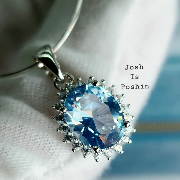 Oval blue topaz pendant necklace in sterling silver